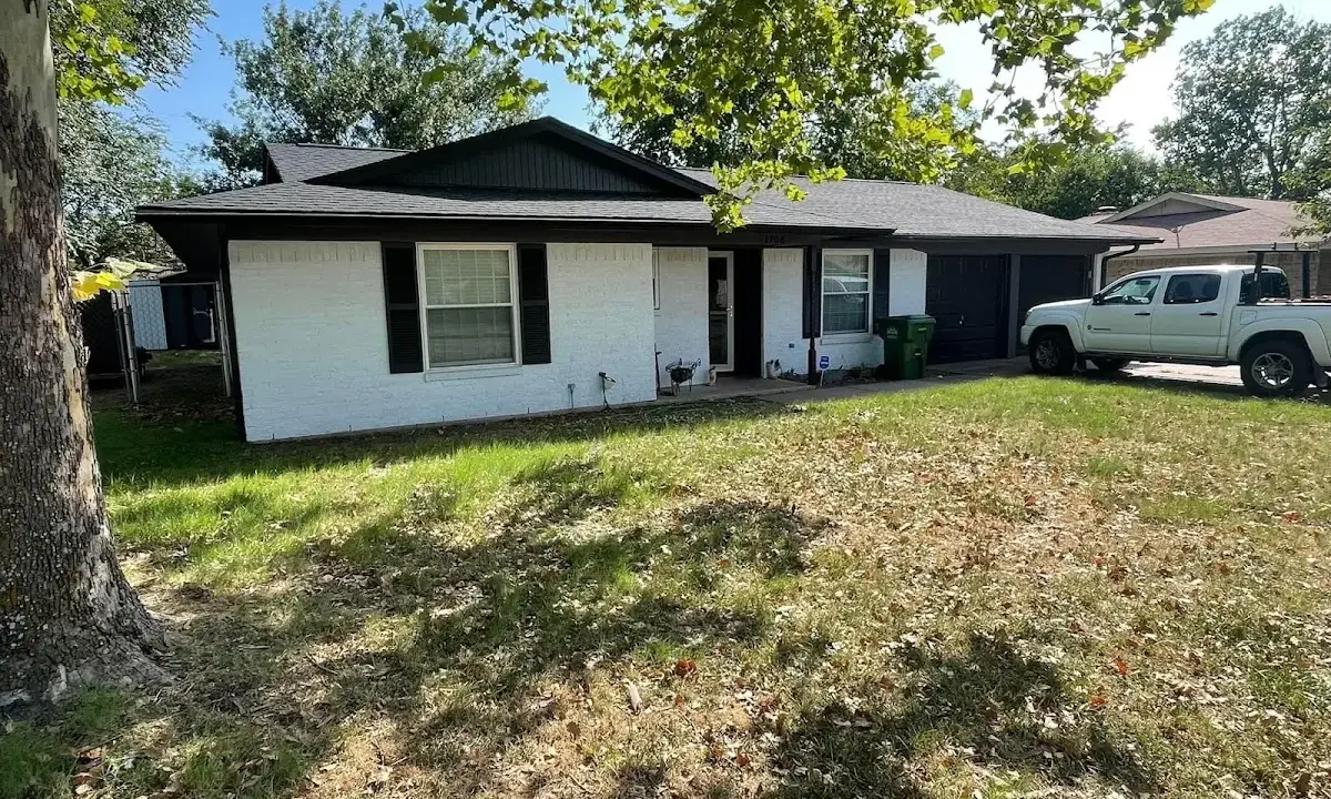 Professional roofing crew working on a residential roof in Grain Valley